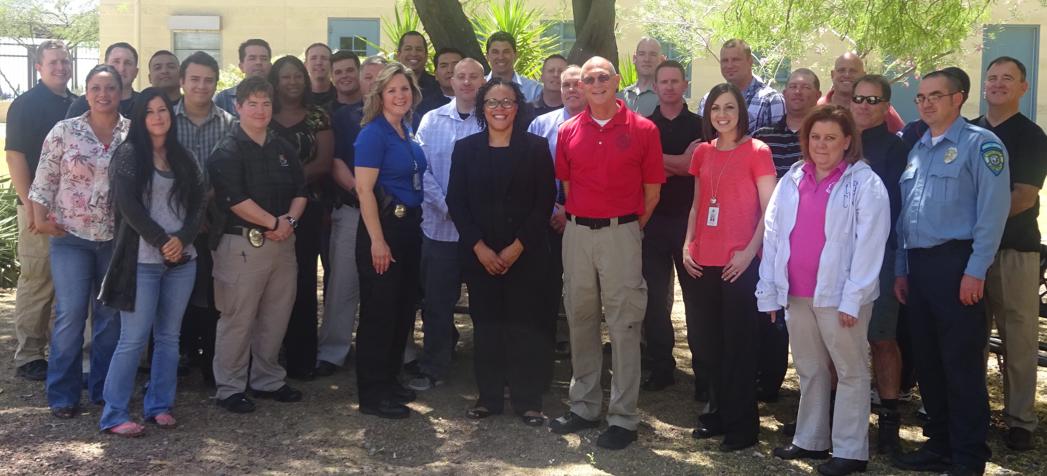 From left to right, Officer Rebecca Skillern (center, blue shirt), Nicola Smith-Kea of the CSG Justice Center, and Senior Officer Frank Webb stand with the Apache Junction CIT class.