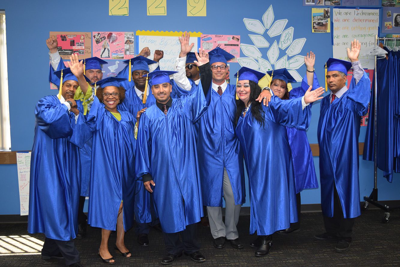 Photo of group of people in blue graduation robes.
