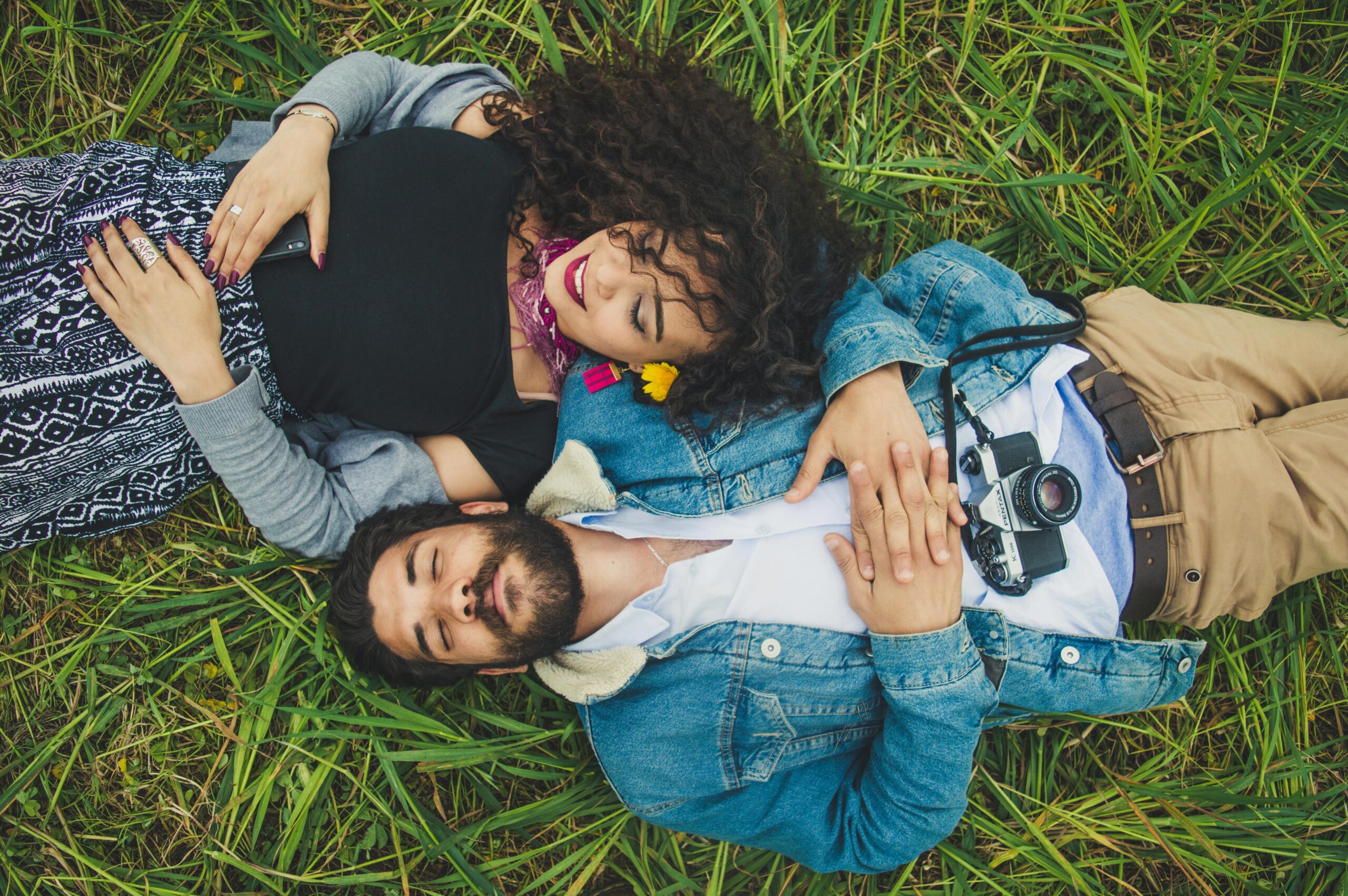 A man and woman laying in the park