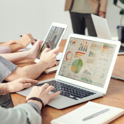 Data analysts looking at charts on laptops