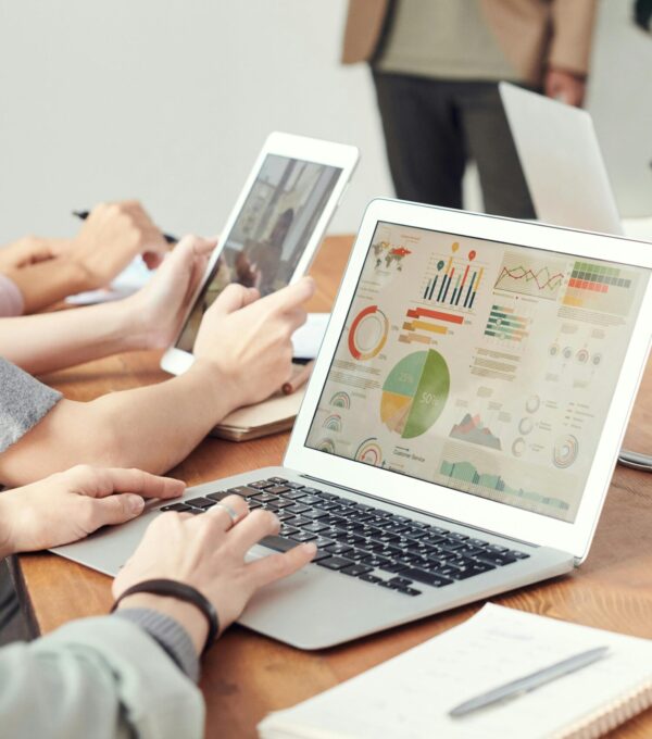Data analysts looking at charts on laptops