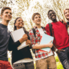 Teens standing and smiling in backpacks