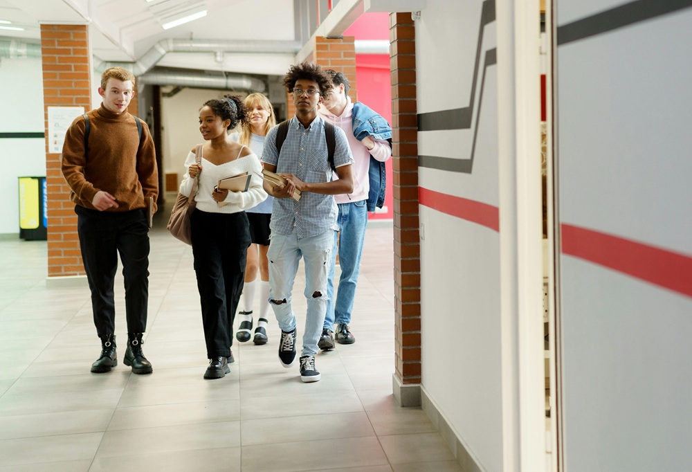 Teens walking in school hallway