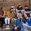 Diverse group of teen students laughing on stairs