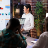 Asian woman giving data presentation with charts and graphs